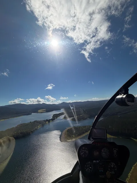 Cockpit view over Lake Tinaroo with sun flare across the water.