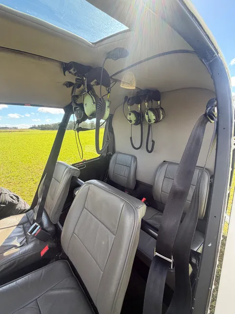 Interior view of the helicopter cabin, leather seats and headsets.